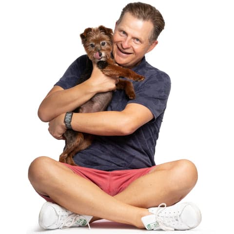 Image of Tom&Sawyer co-founder Peter Zakarow, hugging our mascot Sawyer